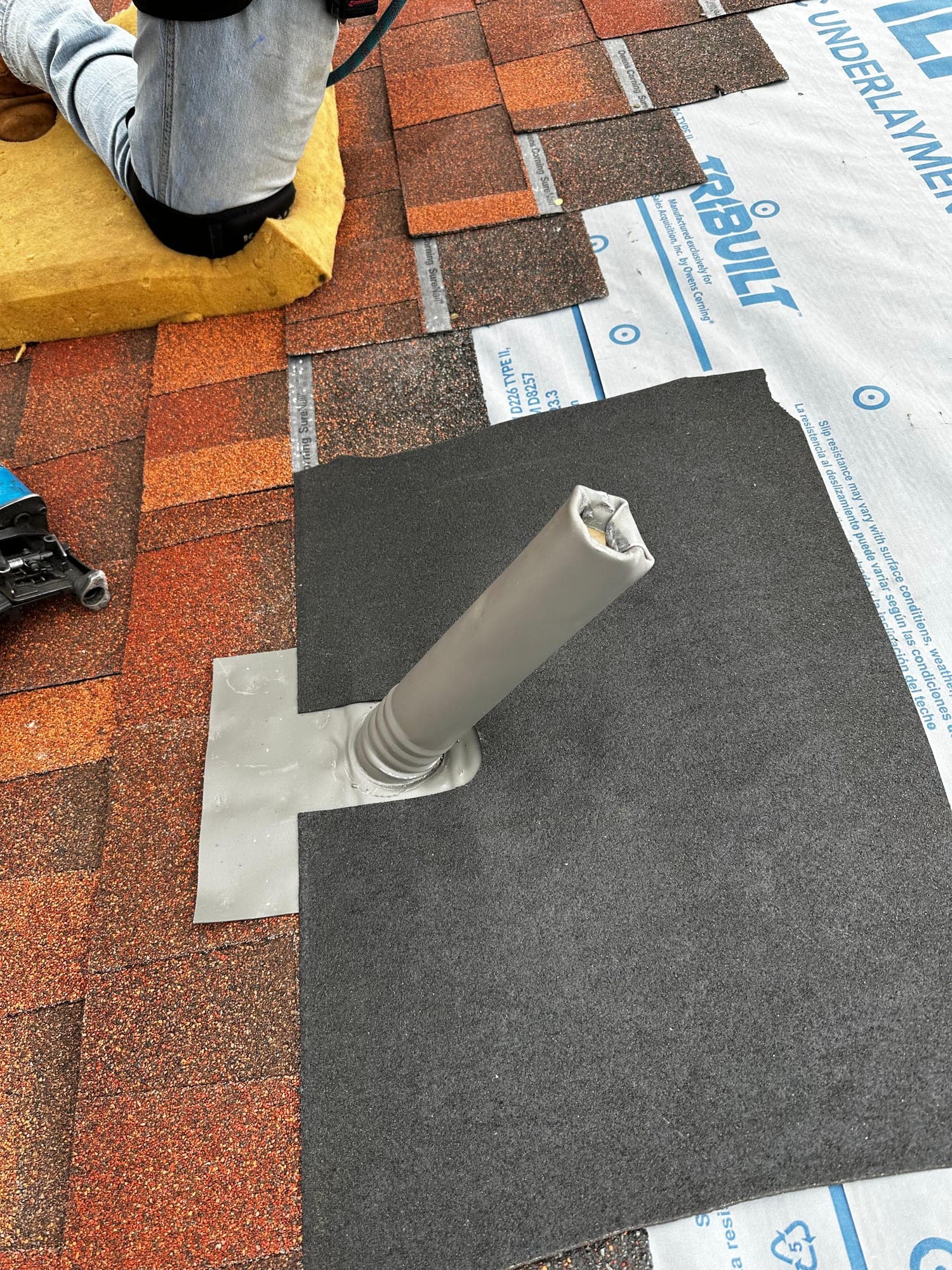 New pipe boot sealed and flashed into fresh shingle courses over TriBuilt underlayment