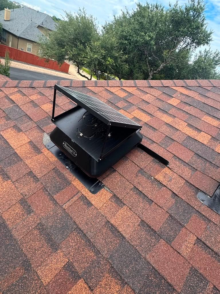 Solar powered attic fan installed and flashed on an architectural shingle roof